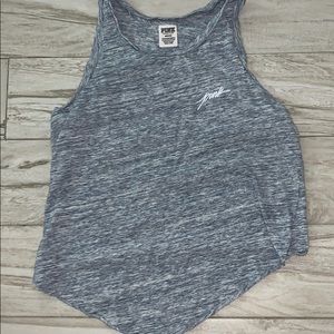 a blue and white shirt with the pink logo on it.